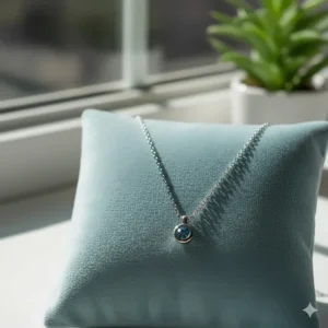 Showcase of a contemporary 14k white gold necklace featuring a bezel-set gemstone.