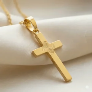Magnified detail of the brilliant, pure 24k gold finish on the cross necklace.