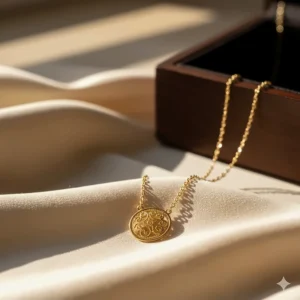Dainty 22k gold necklace with a small, circular pendant featuring a delicate filigree pattern.