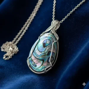 A single abalone shell necklace displayed on a luxurious blue velvet background.
