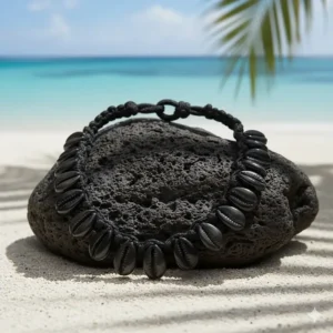 Men's black puka shell necklace variation, featuring dark shells and a knotted cord for a more rugged style.