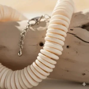 Close-up of the individual puka shells and secure clasp mechanism on the beach necklace.