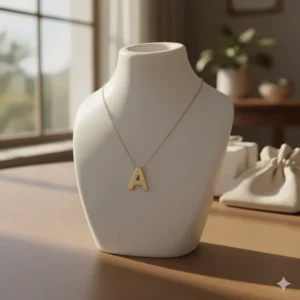The 14k gold initial necklace elegantly displayed on a bust, showing its true size and drop.
