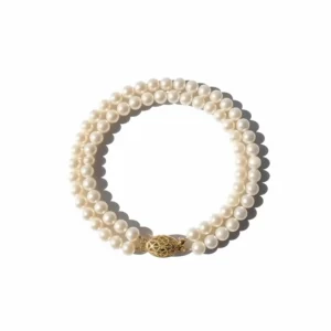Top-down view of the pearl necklace with 14k gold clasp isolated on a clean white background for product photography.