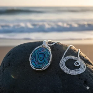 Elegant oval-shaped abalone shell necklace pendant on a sterling silver chain.