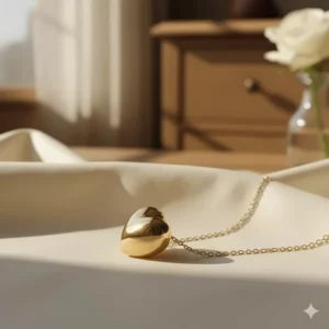 Side profile of the solid 14k gold heart necklace, highlighting its comfortable thickness.