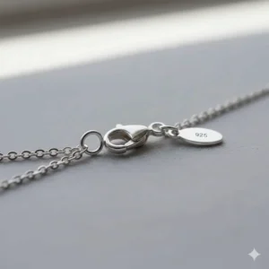 View of the necklace's adjustable chain and secure lobster claw clasp detail for the dolphin jewelry.