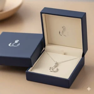 Fish hook necklace presented in a sleek, branded gift box, perfect for an anniversary or birthday present.