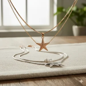 A set of three different necklace starfish designs layered together at varying lengths, demonstrating a popular 2025 jewelry trend.