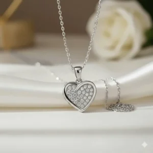 Alternate angle view of a white 14k gold heart pendant necklace with shimmering diamonds.