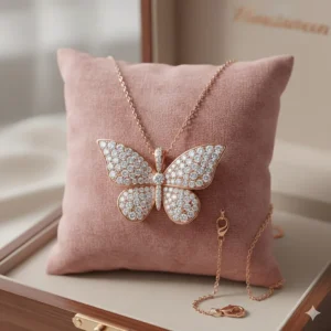 Butterfly pendant necklace in rose gold with diamond accents shown against a soft background.