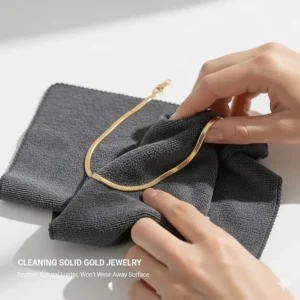 Illustration of a soft cloth polishing a solid gold necklace to restore its natural luster without wearing away the surface.