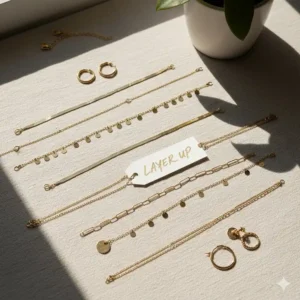 A flatlay of various gold chains and charms ready for everyday necklace gold layering.