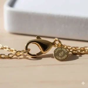 Detailed view of a lead-free and nickel-free lobster clasp on a gold chain for sensitive skin.