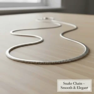 The liquid, smooth texture of a snake chain necklace, a sleek and elegant choice for small and medium-sized pendants.