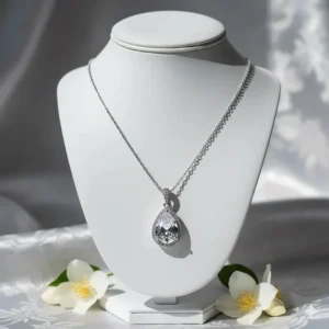 Sophisticated white gold wedding necklace for bride featuring a teardrop crystal.