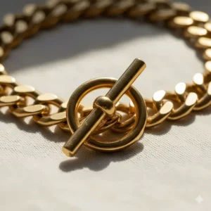 Macro view of a decorative toggle clasp on a chunky gold chain choker.