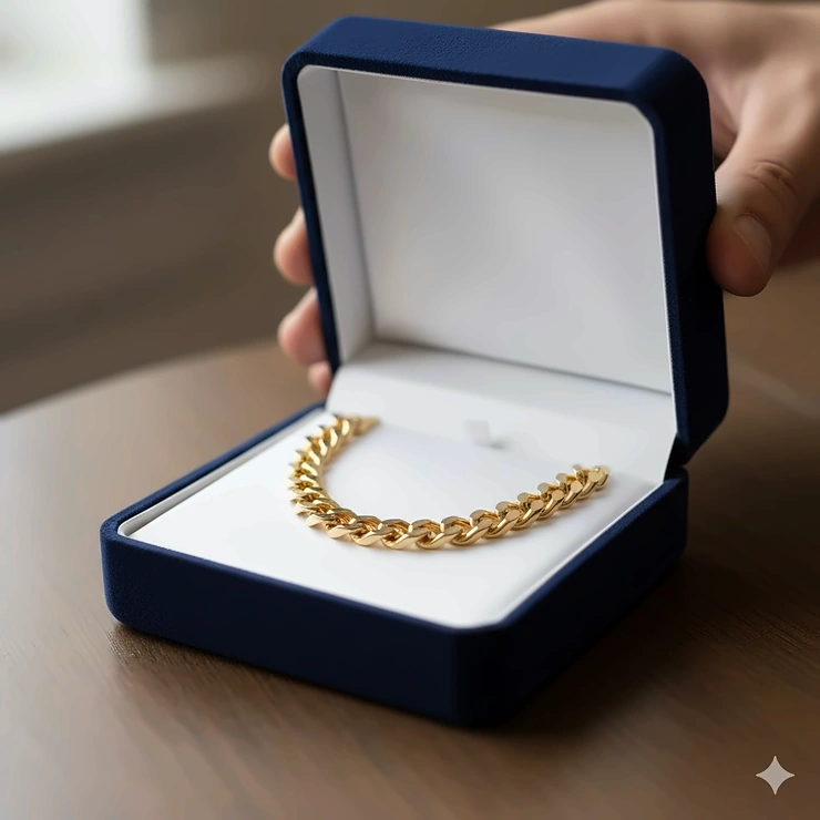 A premium velvet gift box opening to reveal a polished gold necklace for men. gold necklace gift for men