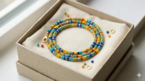 A colorful beaded choker necklace tucked into a minimalist eco-friendly gift box.