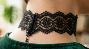 Close-up shot of the intricate floral embroidery on a black lace choker necklace for women.