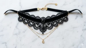 Flatlay view of a handmade black lace choker necklace for women on a marble surface.