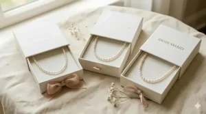 Set of matching bridesmaid pearl choker necklaces displayed in personalized jewelry gift boxes.