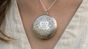 Close-up of the intricate floral engraving on the front of a custom 4 picture locket.