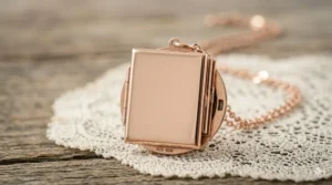 The polished smooth back of a 4 photo locket necklace, suitable for custom date or name engraving.